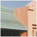 The ogee curve and muted hue of this metal awning and metal cut-out signage hint at fine products within Connolly's Fine Furniture, Fremont, CA.