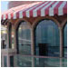 Several types of striped awnings adorn this beach house in La Jolla, CA.