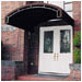 This awning echoes architectural elements as well as providing protection from the weather on the entrance of a home in Piedmont, CA.