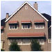 Warm in color and shape, these awnings soften an otherwise stark facade.