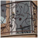 Designed for function as well as form, this intricate iron balcony serves a multifold purpose.